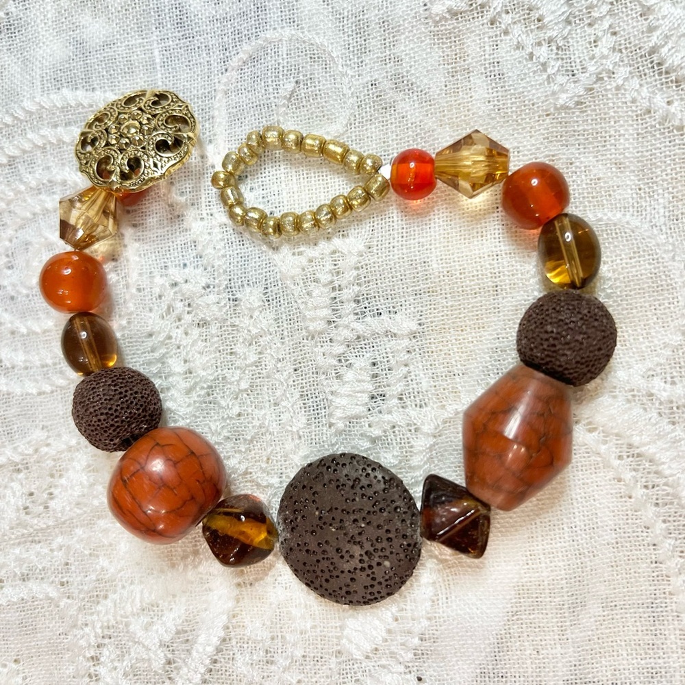 9” boho style bracelet in oranges, browns, and golds. These are great stackables